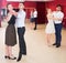 Adult dancing couples enjoying foxtrot