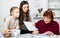 Adult daughter controlling signing of documents by grandmother