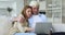 Adult daughter woman teaching senior dad to use online app