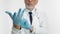 An adult doctor puts medical gloves on hands. In the studio, a doctor in uniform puts on rubber gloves, a close-up