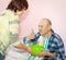 An adult elder daughter takes care of an old sick father