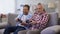 Adult father and son playing video game having fun together, leisure activity