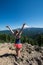 Adult female hiker stands on the top of the Tom and Harry mountain in the Hood River National Forest, overlooking