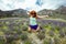 Adult female jumps in a field of purple lupine wildflowers in the June Lake Loops in the Eastern Sierra mountains of California.