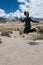 Adult female jumps in a pile of rocks at the Alabama Hills area in Lone Pine California in the Eastern Sierra Nevada Mountains