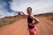 An adult female shows a forced perspective view of Mexican Hat