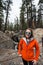 Adult female stands next to the earthquake fault line in Mammoth lakes to show scale of the California quake damage