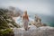 Adult female staying and enjoy Praia da Ursa Beach on morning. Surreal misty scenery of Sintra, Portugal. Atlantic Ocean