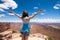 Adult female takes in the scenic view on a breezy day in Canyonlands National Park - Island in the Sky area