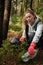 Adult female volunteer cleans garbage and plastic that pollutes environment in forest