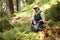 Adult female volunteer cleans garbage and plastic that pollutes environment in forest