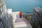 Adult female walks down on the Forty Steps on the Rhode Island Cliff Walk on a spring day