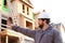 Adult foreman and engineer giving indication on construction site and wearinhg hardhat.