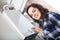 Adult girl in shirt near boiler control panel