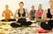 Adult girls making yoga meditation in lotus pose