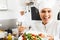 Adult glad female cook holding plate