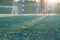 Adult goalkeeper in football sportswear at the gate in the light of the evening sun. Sport concept.