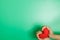 Adult hands holding red heart isolated on green background, health care, donate and family insurance concept