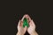 Adult hands holds green ribbon on black background. World lymphoma awareness day. September 15. Liver, Gallbladders bile