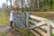 Adult hiker opening gate to exit Dutch nature reserve Geleenbeekdal