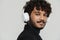 Adult indian handsome curly man in headphones