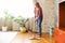 Adult lady cleaning floor at home