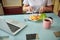 Adult lady operating a knife and a fork while having breakfast