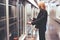 Adult lady stands with a suitcase in airport subway