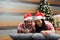 Adult Latino man and woman couple have Christmas presents lying on the bed by the tree with spheres give each other hugs and kisse