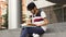 Adult male asian student sitting on stairs and reading book