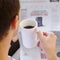 Adult Male Drinking Coffee Reading A Newspaper