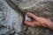 Adult male handholding on to a rock