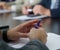 An adult male politician, lawyer, teacher or office worker holds a ballpoint pen during a business meeting, negotiation or