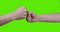 Adult male and teen female hands fist hit over green screen