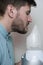 An adult man breathes steam, treats the airways with a nebulizer at home