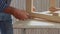 Adult man carpenter making a small wooden table. Fixing wooden plank with screw. By manual screwdriver.  Very close up view. 