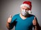 Adult man in Christmas decorated mask, Gesturing Thumbs Up. celebrate xmas holidays at home because coronavirus.