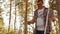 Adult man constructing picnic table in autumn forest. Father building table for family picnic in countryside forest