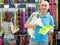 Adult man with dog looking bowl in pet store