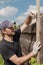 An adult man is engaged in carpentry work at a house construction site