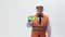 Adult man engineer shows green phone screen, standing in a helmet and a work vest on white studio background. Engineer