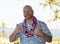 Adult man on Hawaiian vacation wearing a fresh orchid lei