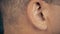 Adult man listening music. Man right ear. Macro extreme close up view of male ear. Concept for audio music sound health