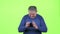 Adult man is looking at the phone for a message. Green screen. Slow motion