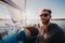 Adult man on marina sport boat portrait happy relaxed on a sunset