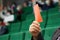 An adult man - participant of elections or voting holds a red card in his hands. Protest voting, banning or disagreeing with the