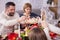 Adult man passing the salad over the table at family christmas feast