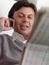 Adult man reading stock exchange listings at home