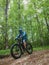 An adult man rides down the mountain on an electric fatbike