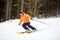 Adult man skiing during speedy racing along the mountain slope. Concept of healthy lifestyle and active winter pastime